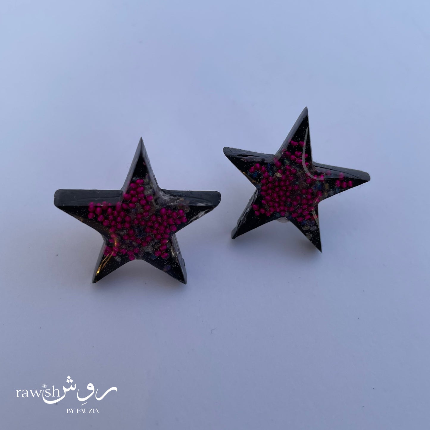 Black star studs with pink rhinestones