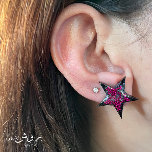 Black star studs with pink rhinestones